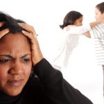 Minority woman with her children fighting in the background