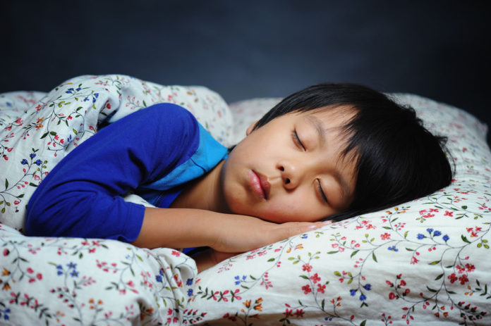 a_child_sleeping_on_the_bed